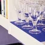 Antidérapant Dycem bleu posé sur une étagère pour stabiliser des verres à pied