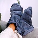 Paire de chaussons à chauffer en graines de lin gris anthracite portés aux pieds.