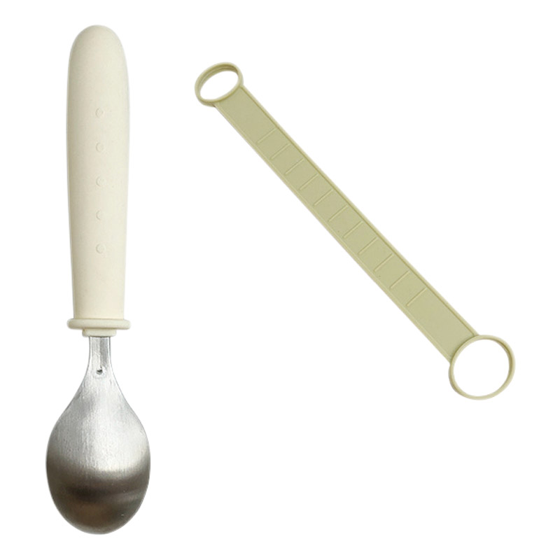 Cuillère ergonomique avec une lanière de maintien à la main